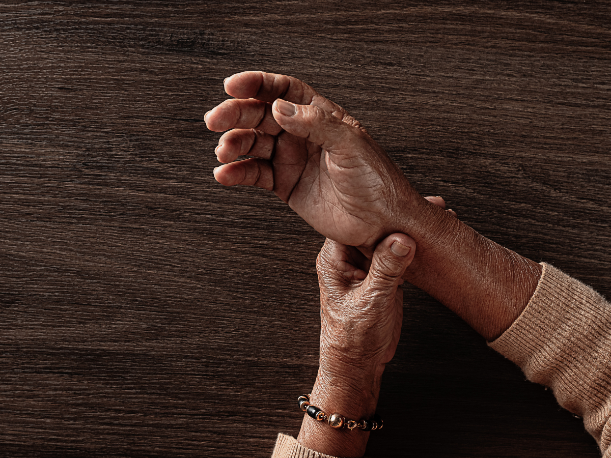 a person holding their wrist 